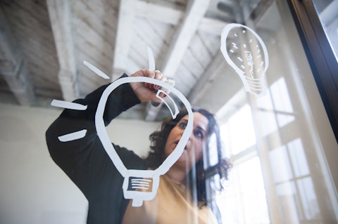 Drawing a lightbulb on glass with a chalk marker Getty Images 1141931576